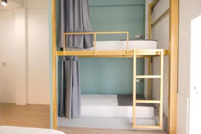 a room with bunk beds in it at Hugger Hostel in Phuket Town
