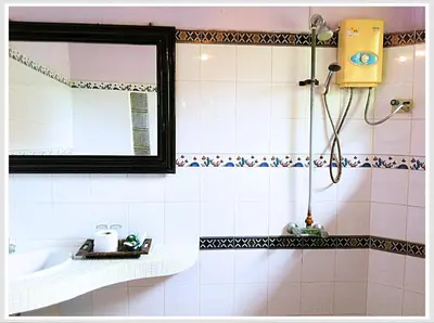 a bathroom with a tub and a mirror and a sink at The Emerald Krabi Beach Resort in Klong Muang Beach