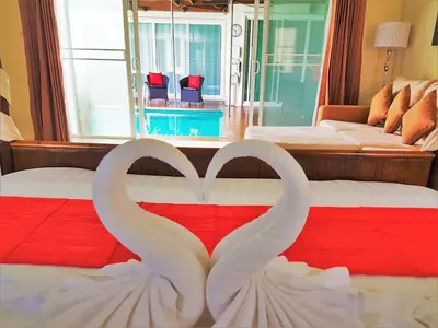 two white swans forming a heart on a bed at Prima Villas Karon Beach by PHR in Karon Beach