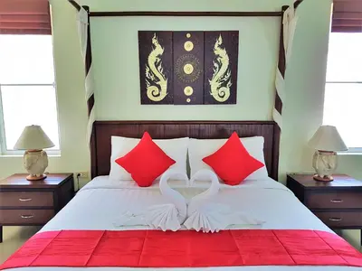 a bedroom with a bed with red and white pillows at Prima Villas Karon Beach by PHR in Karon Beach