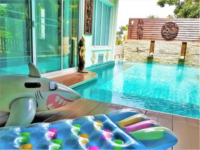 a swimming pool with a toy shark laying next to it at Prima Villas Karon Beach by PHR in Karon Beach