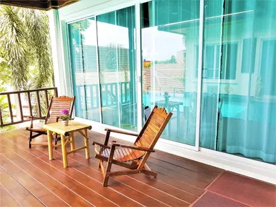 two rocking chairs and a table on a porch at Prima Villas Karon Beach by PHR in Karon Beach