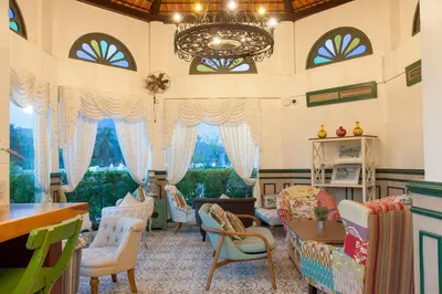 a living room with chairs and a chandelier at Supicha Pool Access Hotel - SHA Plus in Phuket Town