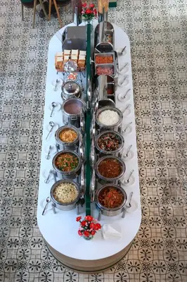 a buffet of food on a table with condiments at Supicha Pool Access Hotel - SHA Plus in Phuket Town