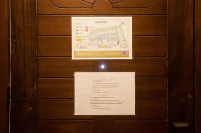 a sign on a wooden wall with a map at Supicha Pool Access Hotel - SHA Plus in Phuket Town