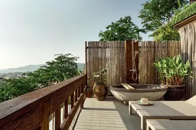 a bathroom with a tub on a wooden deck at Dinso Resort & Villas Phuket, Vignette Collection by IHG in Patong Beach