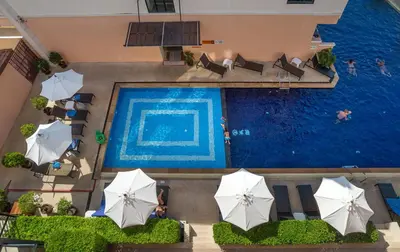 an overhead view of a swimming pool with umbrellas at Srisuksant Resort in Ao Nang Beach