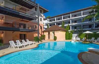a swimming pool in front of a building at Srisuksant Resort in Ao Nang Beach