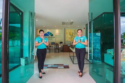 two women in blue shirts are walking in a building at Phu Dahla Residences in Ao Nang Beach