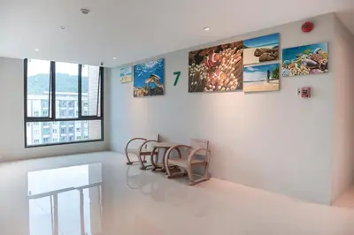 a room with a table and chairs on the wall at Phu Dahla Residences in Ao Nang Beach