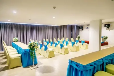 a conference room with a table and chairs with blue tables and white chairs at Phu Dahla Residences in Ao Nang Beach