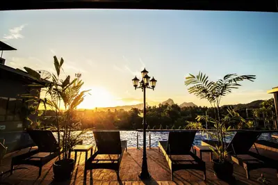 a patio with chairs and a light pole and water at Phu Dahla Residences in Ao Nang Beach