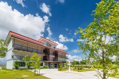 a building with a blue sky in the background at Phant at Thalang Service Apartment in Thalang