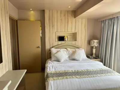 a bedroom with a large bed with white pillows at Condo Minium Patong Phuket in Patong Beach