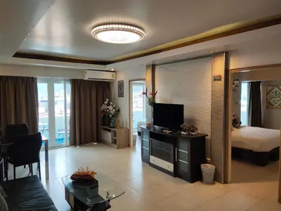 a living room with a television and a bedroom at Condo Minium Patong Phuket in Patong Beach