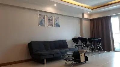 a living room with a couch and a table and chairs at Condo Minium Patong Phuket in Patong Beach
