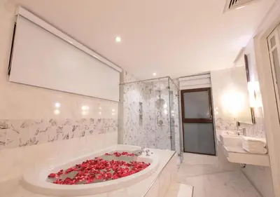 a bathroom with a large tub filled with red hearts at IndoChine Resort and Villas in Patong Beach