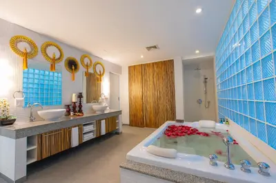 a bathroom with two sinks and a bath tub at IndoChine Resort and Villas in Patong Beach