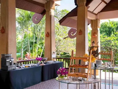 a table with a blue table cloth and some food at Novotel Phuket Resort in Patong Beach