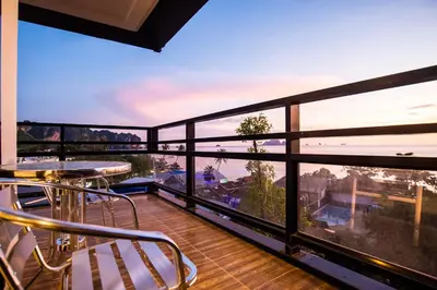 a balcony with chairs and a view of the city at Days Inn by Wyndham Aonang Krabi in Ao Nang Beach