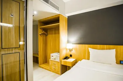 a bedroom with a bed and a night stand with a telephone at Days Inn by Wyndham Aonang Krabi in Ao Nang Beach