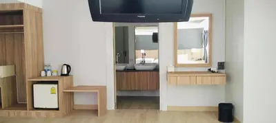 a bathroom with a sink and a tv on a wall at Days Inn by Wyndham Aonang Krabi in Ao Nang Beach