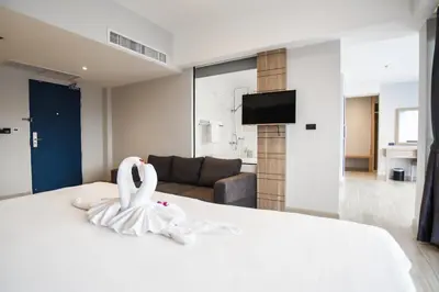 a bedroom with a bed with a swan on it at Days Inn by Wyndham Aonang Krabi in Ao Nang Beach