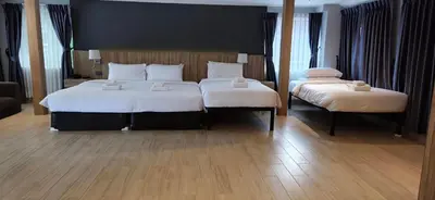 a bedroom with two beds with white sheets at Days Inn by Wyndham Aonang Krabi in Ao Nang Beach