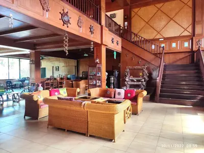 a living room with couches and a staircase in a building at Andamanee Boutique Resort Aonang Krabi - Free Beach Shuttle in Ao Nang Beach