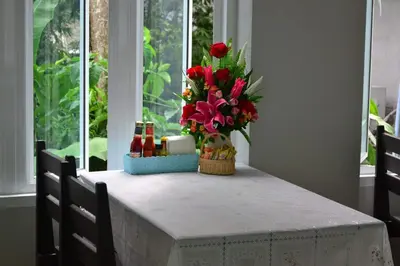 a table with a vase of flowers on it at Aonang Village Resort in Ao Nang Beach