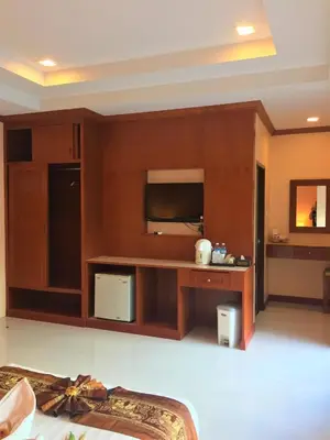 a living room with a tv and a couch at Aonang Village Resort in Ao Nang Beach