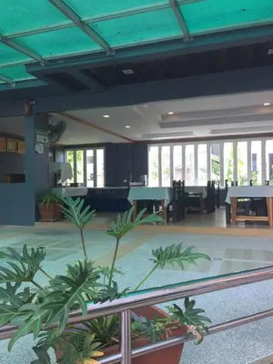a lobby with palm trees in a building at Aonang Village Resort in Ao Nang Beach
