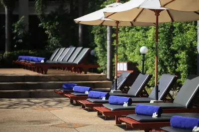 a row of empty chairs with umbrellas and stairs at Deevana Patong Resort & Spa in Patong Beach