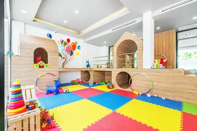 a childs play room with a bed and a colorful floor at Kokotel Krabi Oasis in Ao Nang Beach