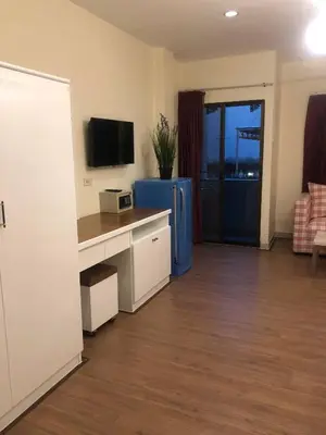 a living room with a desk and a television at DB Residence in Patong Beach