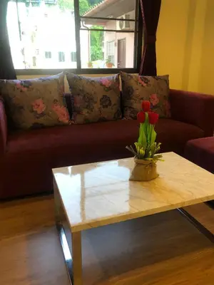a living room with a couch and a coffee table at DB Residence in Patong Beach