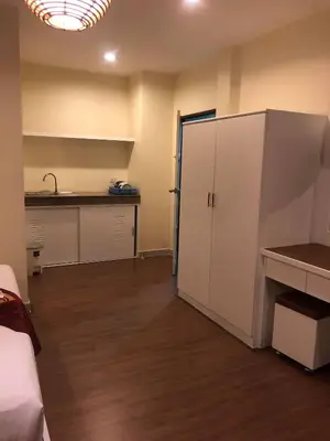 a room with a white cabinet and a kitchen at DB Residence in Patong Beach