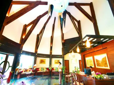 a large room with a ceiling with wooden beams at Ao Nang Timber House in Ao Nang Beach