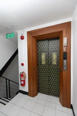 a door in a building with a fire hydrant next to it at Hotel Sole in Patong Beach
