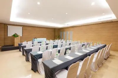 a large room with rows of tables and chairs at Blue Tara Hotel Krabi Ao Nang in Ao Nang Beach