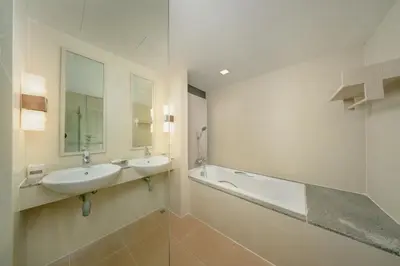 a bathroom with a sink and a bath tub at Blue Tara Hotel Krabi Ao Nang in Ao Nang Beach