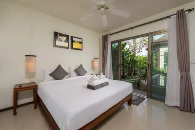 a bedroom with a large white bed and a window at Villa Adonara Private Pool Escape Near Nai Harn in Nai Harn Beach