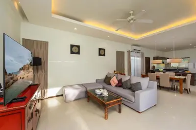 a living room with a couch and a flat screen tv at Villa Adonara Private Pool Escape Near Nai Harn in Nai Harn Beach