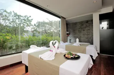 a room with three swans in towels on tables at Malisa Villa Suites - SHA Extra Plus in Kata Beach