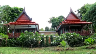 a house with two gazebos in a garden at Phi Phi Natural Resort in Phi Phi Don