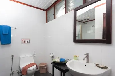 a bathroom with a sink and a toilet and a mirror at Phi Phi Natural Resort in Phi Phi Don