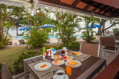 a table with breakfast food on it with a view of the beach at Phi Phi Natural Resort in Phi Phi Don