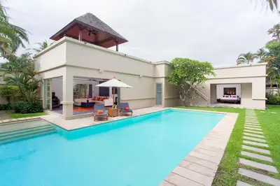 a swimming pool in front of a villa at The Residence Resort in Bang Tao Beach