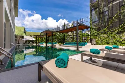 an image of a swimming pool at a resort at OUTRIGGER Surin Beach Resort in Surin Beach