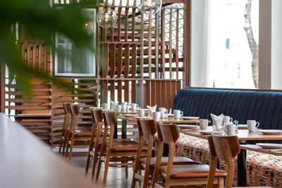 a row of tables and chairs in a restaurant at OUTRIGGER Surin Beach Resort in Surin Beach